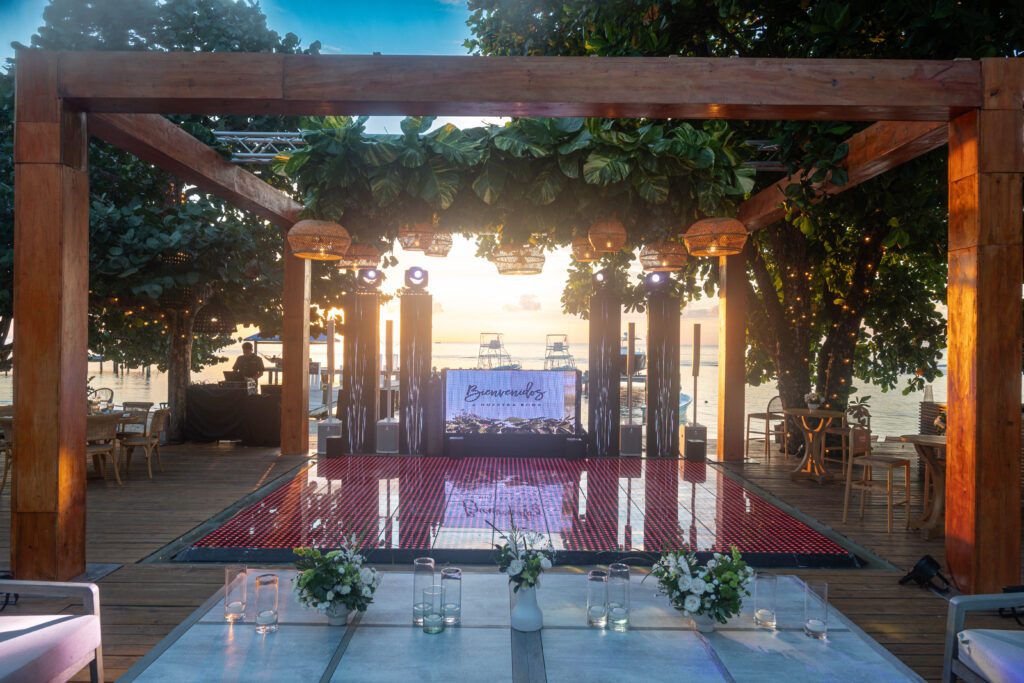 Wedding pergola and dance floor at sunset, built by MaxStage